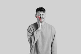 Man holding cheek with sinus tooth pain and upper jaw pressure discomfort